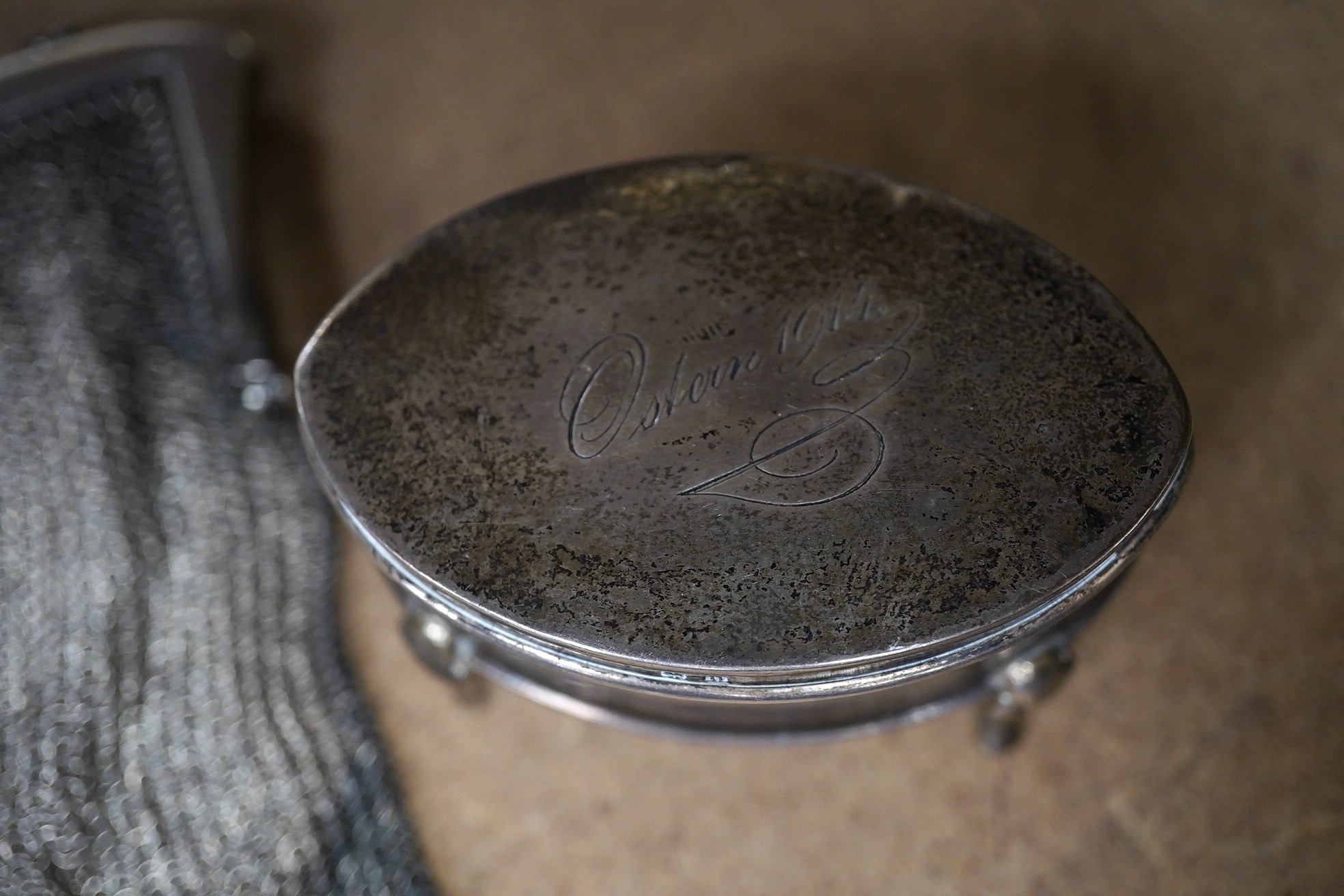 A George V silver trinket box, 68mm, a silver vesta case and two silver mesh evening bags. Condition - poor to fair